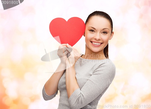 Image of smiling asian woman with red heart