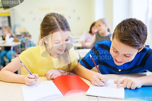 Image of group of school kids writing test in classroom