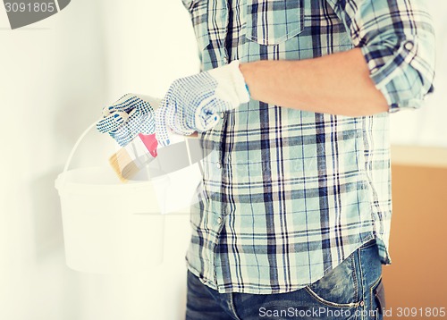 Image of man with paintbrush and pot