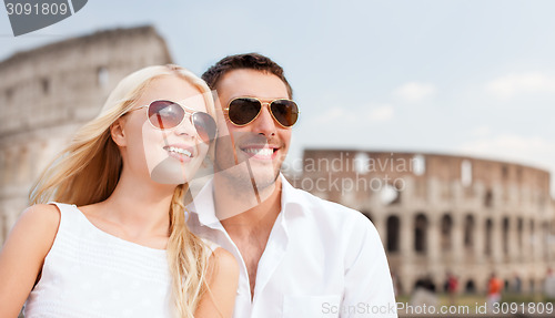 Image of happy couple hugging over coliseum