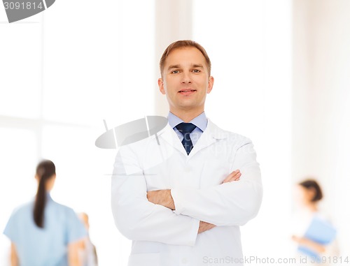 Image of smiling male doctor in white coat