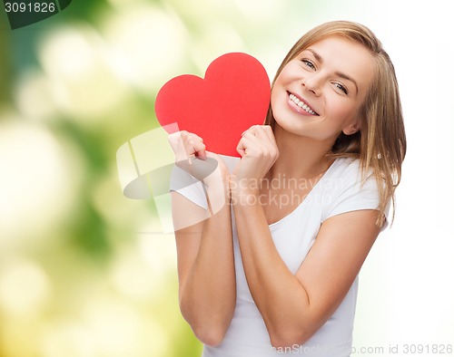 Image of smiling woman in white t-shirt holding red heart