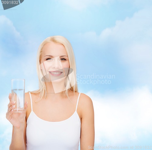 Image of young smiling woman with glass of water