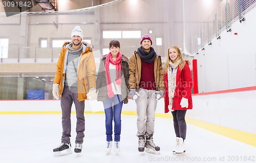 Image of happy friends on skating rink