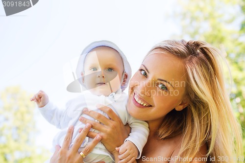 Image of happy mother with little baby outdoors