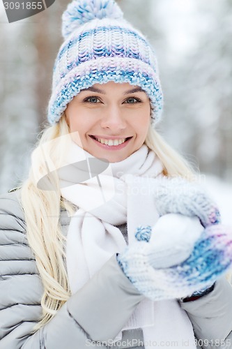 Image of smiling young woman in winter forest