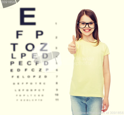 Image of smiling cute little girl in black eyeglasses