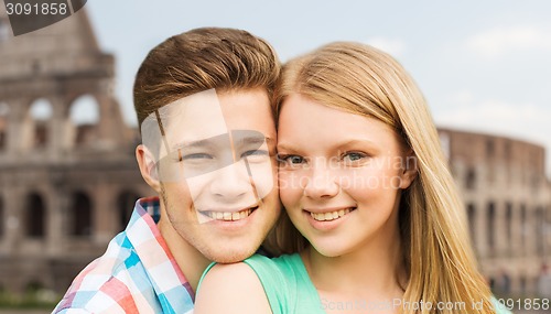 Image of smiling couple over coliseum background