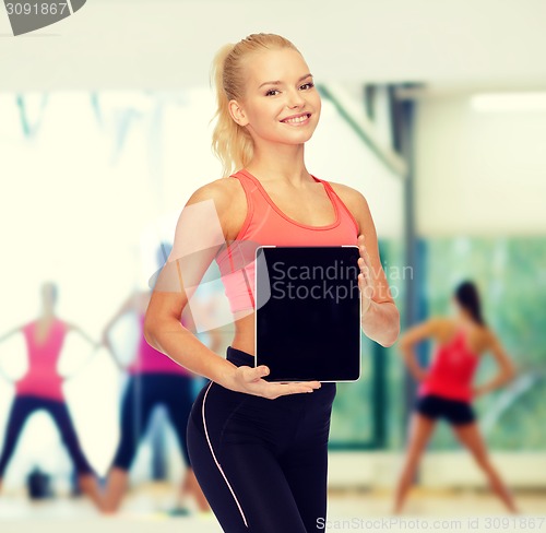 Image of smiling woman showing tablet pc blank screen