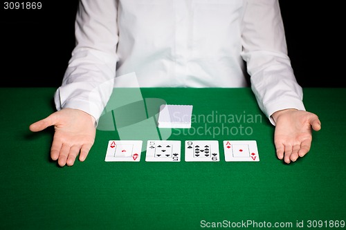 Image of holdem dealer with playing cards