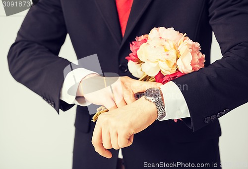 Image of man giving bouquet of flowers