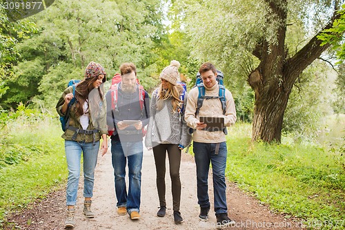 Image of group of friends with backpacks and tablet pc