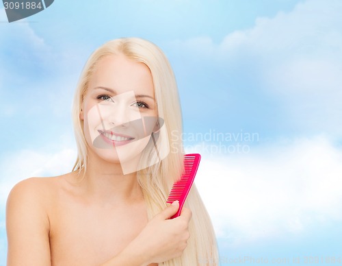 Image of smiling woman with hair brush