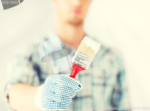 Image of man hand with paintbrush