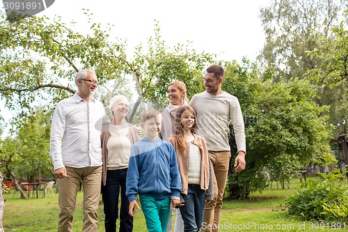 Image of happy family in front of house outdoors