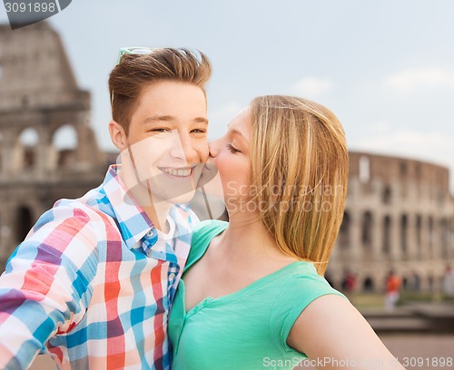Image of couple kissing and taking selfie over coliseum
