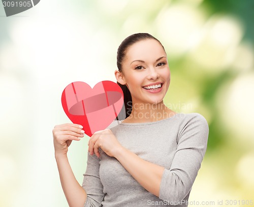 Image of smiling asian woman with red heart