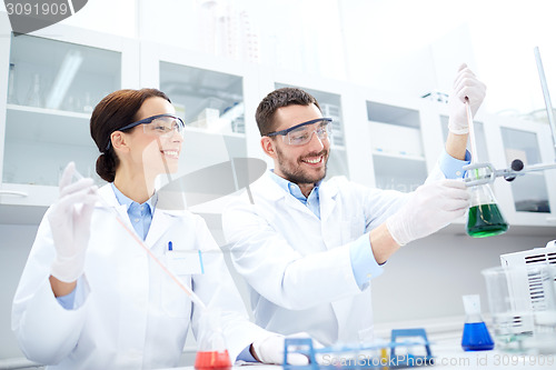 Image of young scientists making test or research in lab