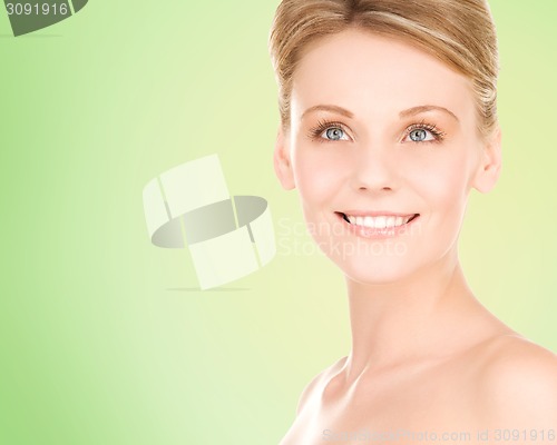 Image of close up of smiling woman over green background