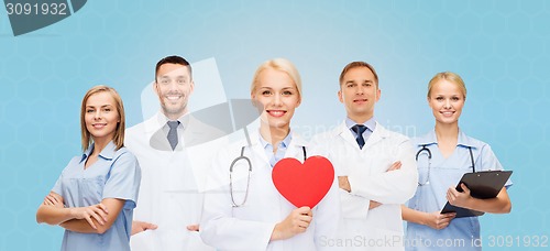 Image of group of smiling doctors with red heart shape