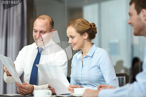 Image of business people with papers meeting in office