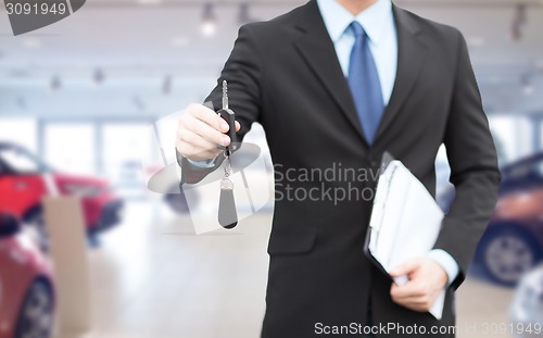 Image of close up of businessman or salesman giving car key