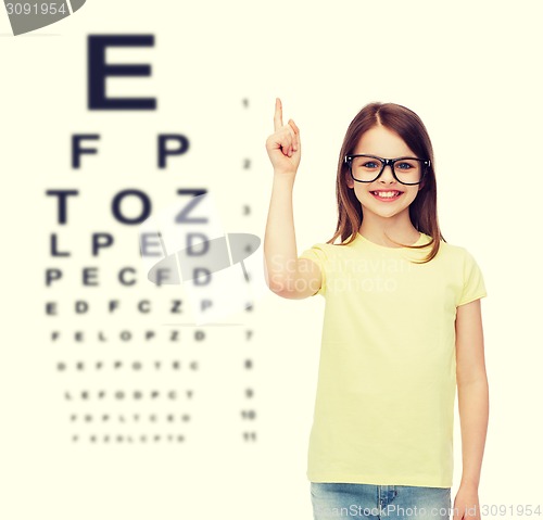 Image of smiling cute little girl in black eyeglasses