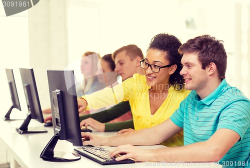 Image of smiling students in computer class at school