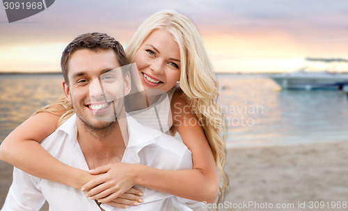 Image of happy couple having fun over beach background