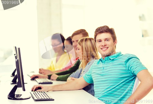 Image of male student with classmates in computer class