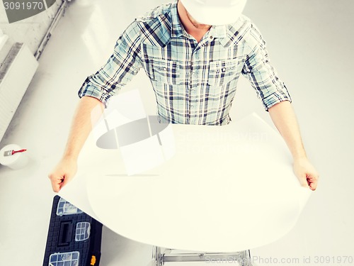 Image of man architect with helmet and blueprint