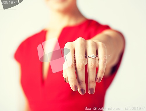 Image of woman showing wedding ring on her hand