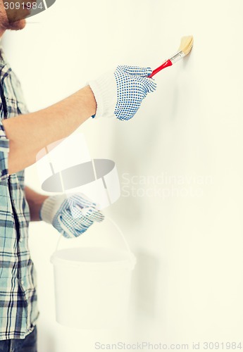 Image of man with paintbrush and pot