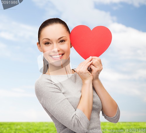 Image of smiling asian woman with red heart