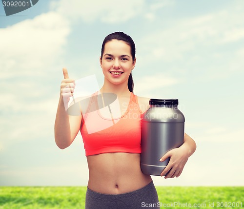 Image of teenage girl with jar of protein showing thumbs up