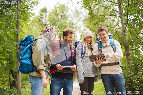 Image of group of friends with backpacks and tablet pc