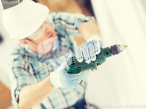 Image of man drilling the wall