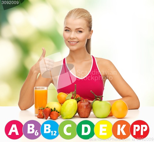 Image of happy woman with organic food and vitamins