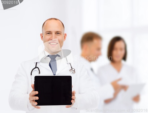 Image of smiling male doctor with stethoscope and tablet pc