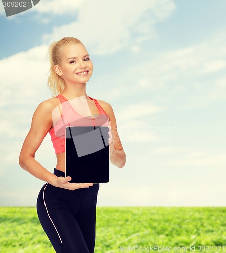 Image of smiling woman showing tablet pc blank screen
