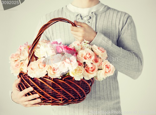 Image of man holding basket full of flowers