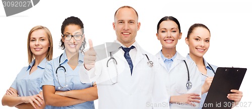 Image of group of smiling doctors with showing thumbs up