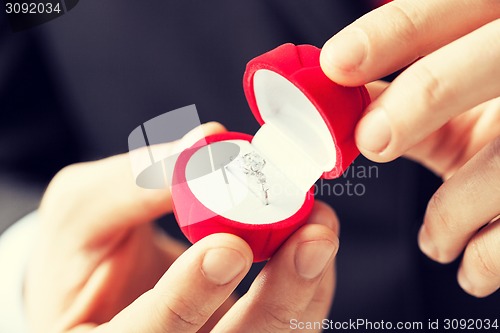 Image of man with wedding ring and gift box