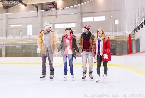 Image of happy friends on skating rink