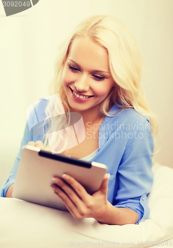 Image of smiling woman with tablet pc computer at home