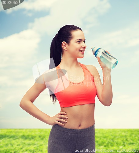 Image of sporty woman with water bottle