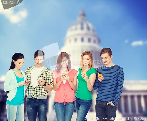 Image of smiling students with smartphones