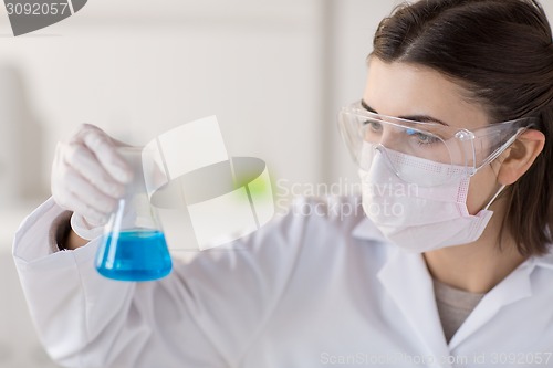 Image of close up of scientist with flask making test