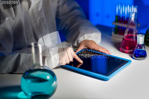 Image of close up of scientist with tablet pc in laboratory