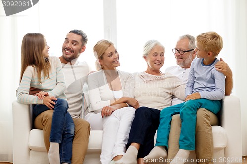 Image of happy family sitting on couch at home